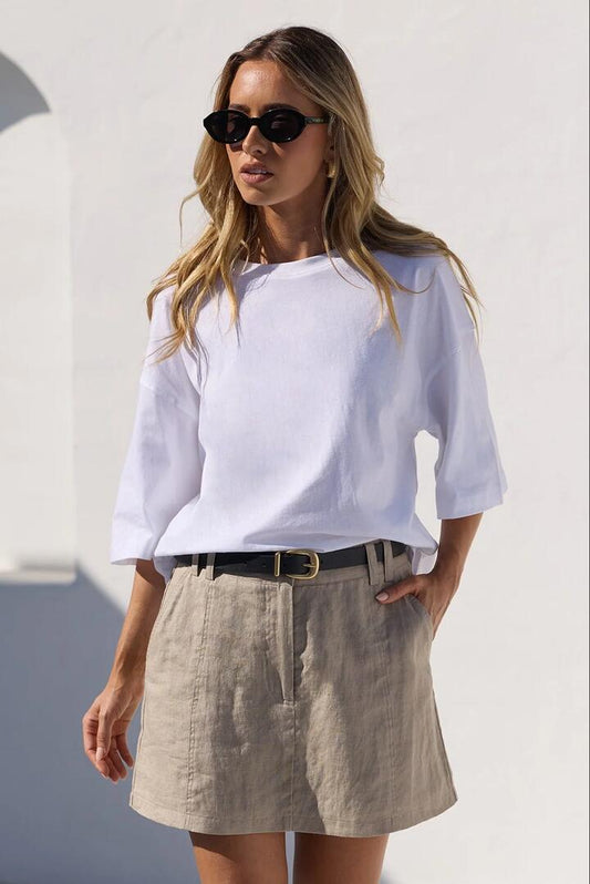 Image of a model wearing Skirts. Product name - Alignment Stone Linen Mini Skort in Stone colour by brand - RE:UNION Label