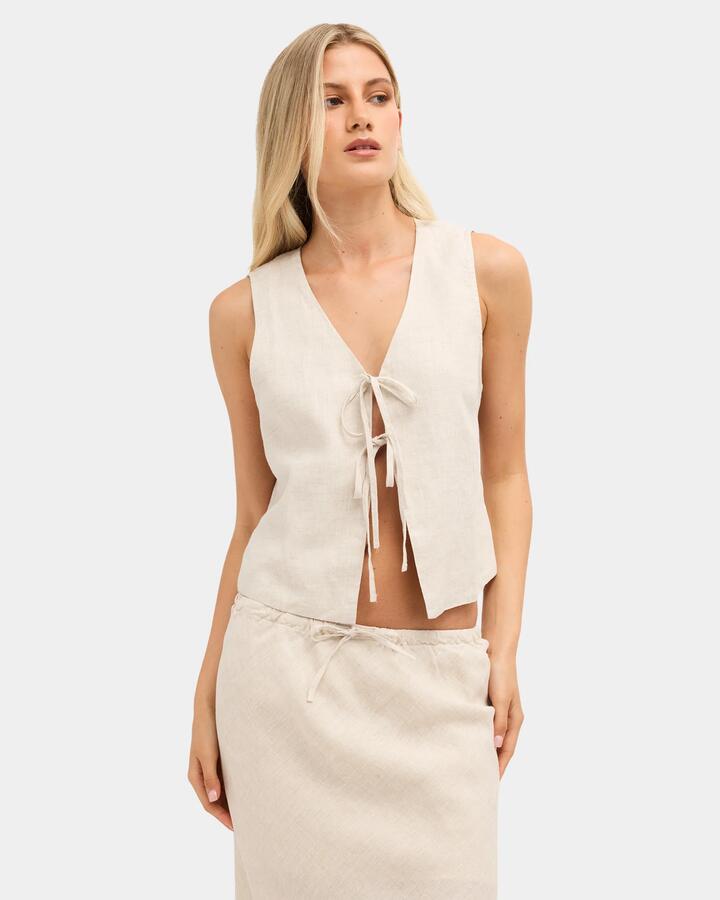 Image of a model wearing Tops. Product name - Nunui Womens Layton Linen Tank Top Natural 3 in Natural 3 colour by brand - Nunui
