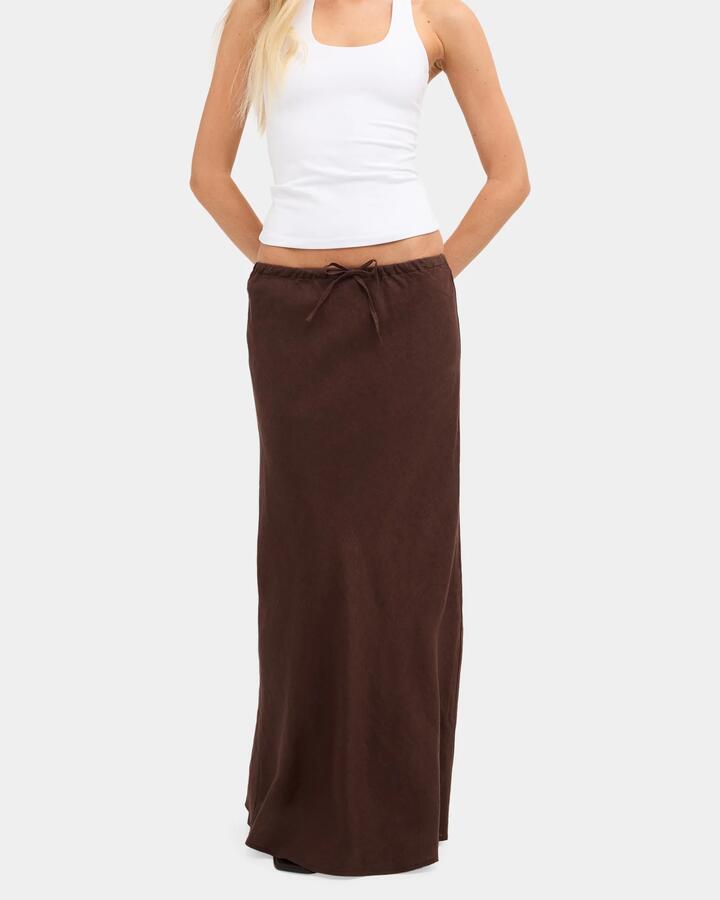 Image of a model wearing Skirts. Product name - Nunui Womens Lyric Linen Maxi Skirt Chocolate 5 in Chocolate 5 colour by brand - Nunui