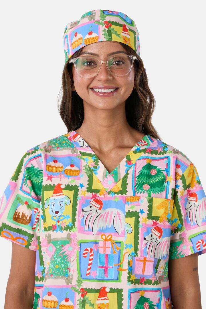 Image of a model wearing Uniforms & Workwear. Product name - Holiday Pups Scrub Hat in Pink colour by brand - Scrubs With Love