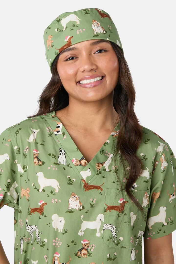 Image of a model wearing Uniforms & Workwear. Product name - Christmas Dogs Scrub Hat in Green colour by brand - Scrubs With Love