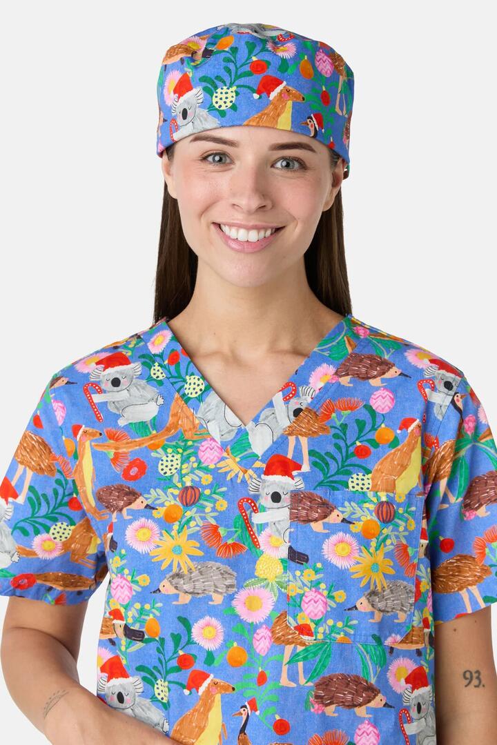 Image of a model wearing Uniforms & Workwear. Product name - Bush Christmas Scrub Hat in Blue colour by brand - Scrubs With Love