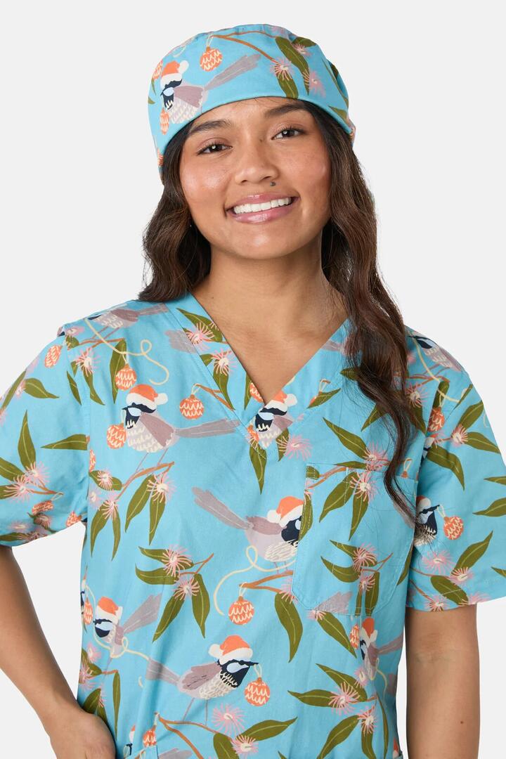 Image of a model wearing Uniforms & Workwear. Product name - Christmas Fairy Wren Scrub Hat in Teal colour by brand - Scrubs With Love