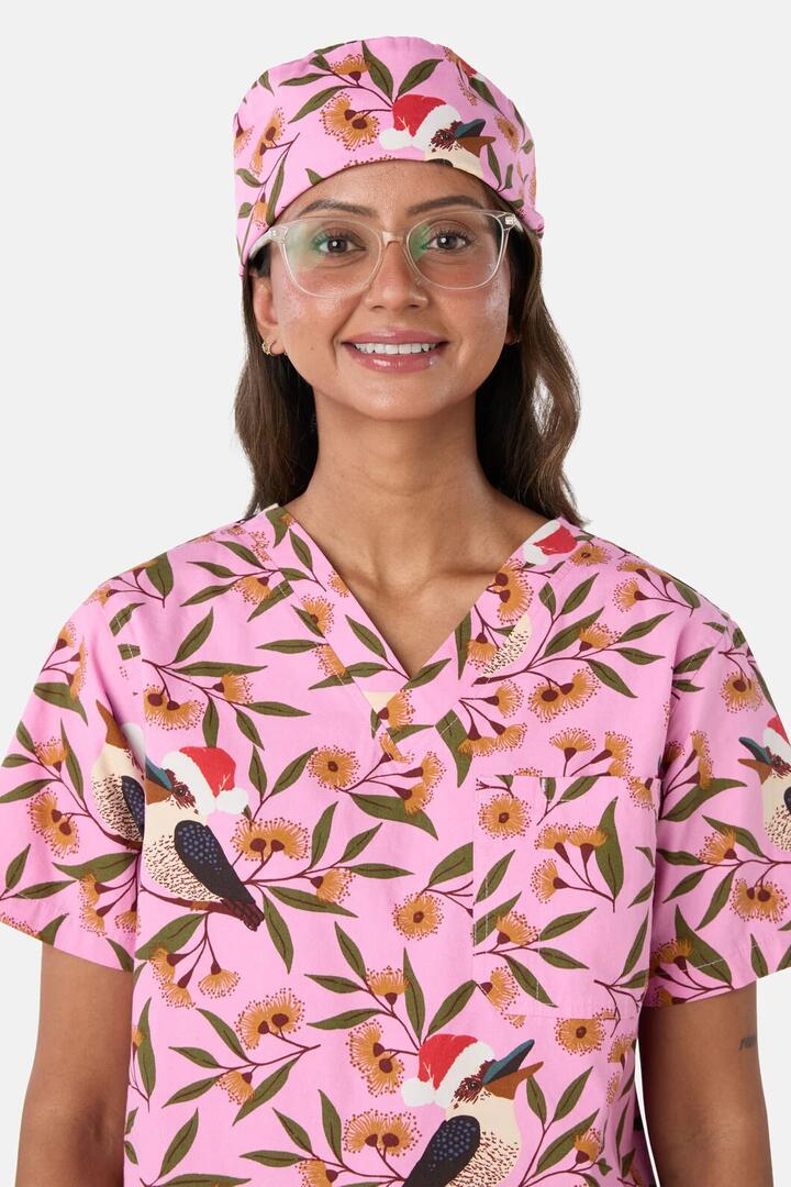 Image of a model wearing Uniforms & Workwear. Product name - Christmas Kookaburra Scrub Hat in Pink colour by brand - Scrubs With Love