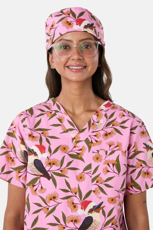 Image of a model wearing Uniforms & Workwear. Product name - Christmas Kookaburra Scrub Hat in Pink colour by brand - Scrubs With Love