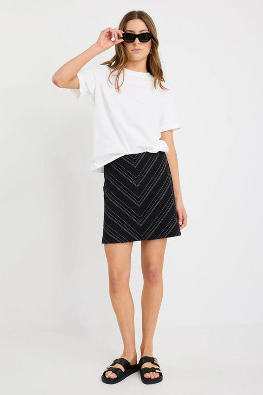 Image of a model wearing Skirts. Product name - Martini Black White Chevron Cotton Blend Mini Skirt in Black White Gradient Stripe colour by brand - Stories be Told