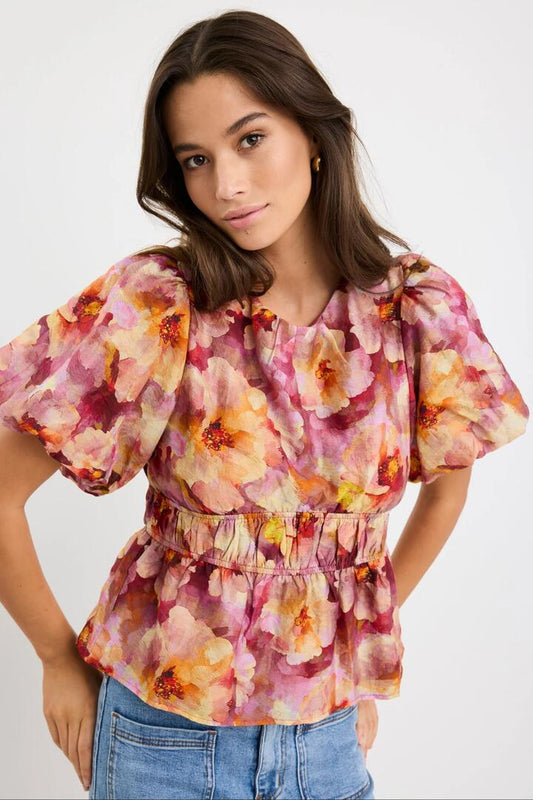 Image of a model wearing Tops. Product name - Provoke Pink Multi Floral Bubble Sleeve Top in Pink Multi Floral colour by brand - Georgia Zoe