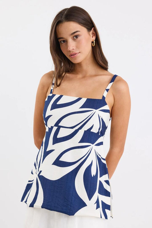 Image of a model wearing Tops. Product name - Sunkissed Navy Cutout Print Split Hem Cami Top in Navy Cutout Print colour by brand - Stories be Told