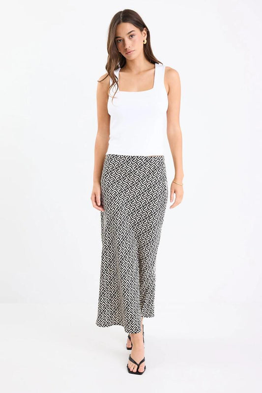 Image of a model wearing Skirts. Product name - Cleo Geometric Satin Bias Cut Maxi Skirt in Geometric colour by brand - Among the Brave