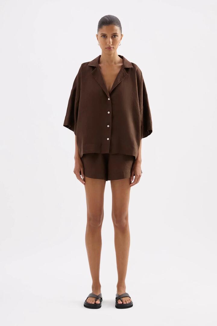 Image of a model wearing Shorts. Product name - Lounge Chocolate Linen Short in Chocolate colour by brand - Nude Lucy
