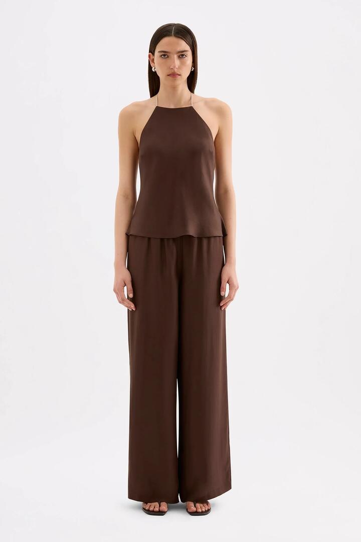 Image of a model wearing Pants. Product name - Tilly Chocolate Tencel Front Tie Pant in Chocolate colour by brand - Nude Lucy