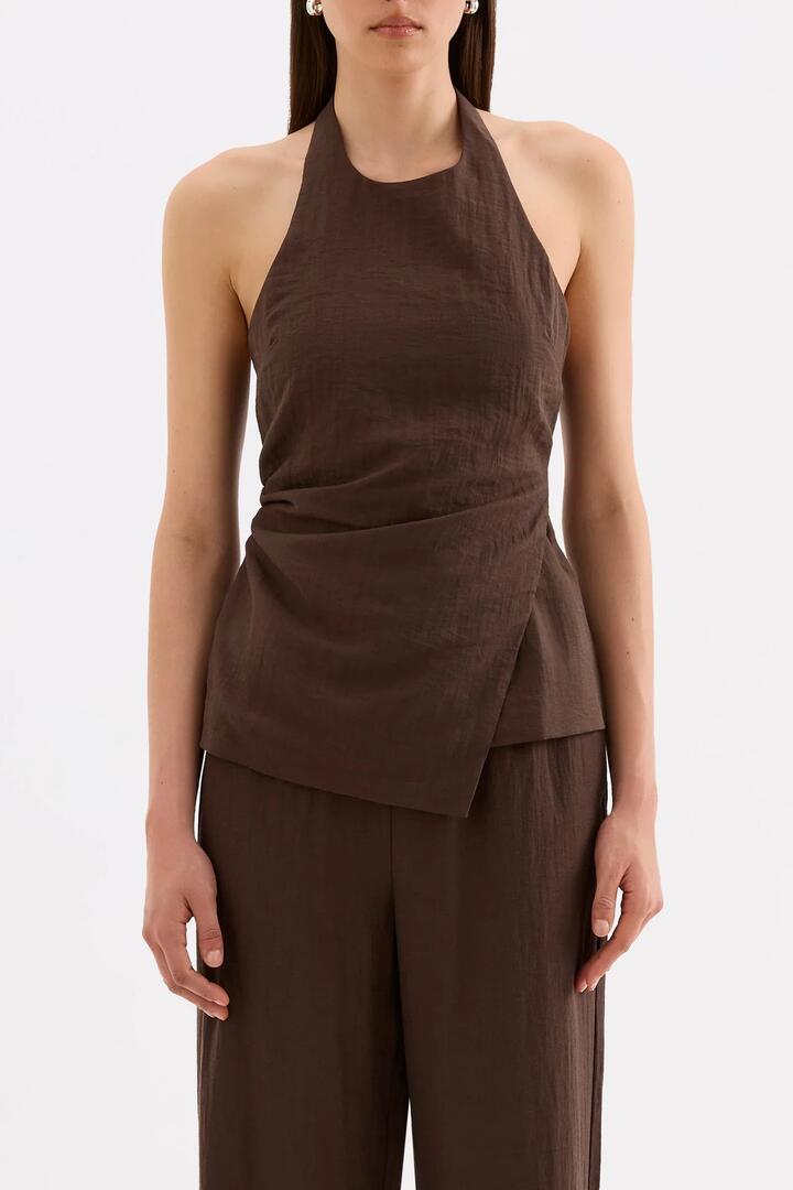 Image of a model wearing Tops. Product name - Juno Chocolate Shirred Back Linen Blend Halter Top in Chocolate colour by brand - Nude Lucy