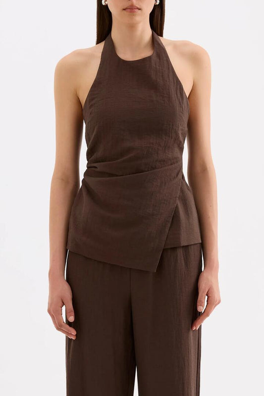 Image of a model wearing Tops. Product name - Juno Chocolate Shirred Back Linen Blend Halter Top in Chocolate colour by brand - Nude Lucy