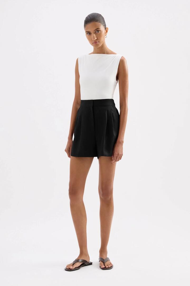 Image of a model wearing Shorts. Product name - Thilda Black Linen Tailored Shorts in Black colour by brand - Nude Lucy