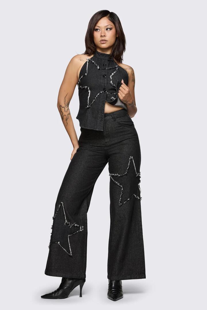 Image of a model wearing Pants. Product name - Sketchy Patch Wide Leg Jean in Black colour by brand - Dangerfield