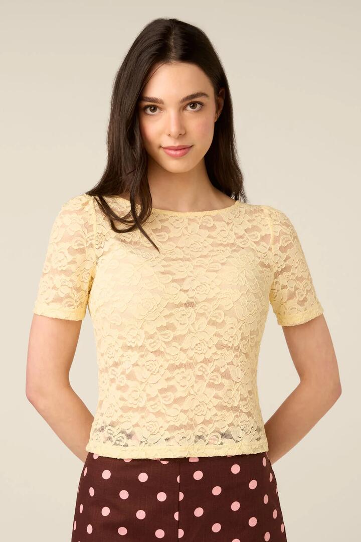Image of a model wearing Tops. Product name - Lacey Short Sleeve Tee in Lemon colour by brand - Princess Highway