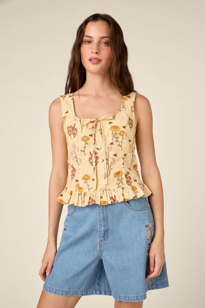 Image of a model wearing Tops. Product name - Native Bee & Flora Corset Top in Lemon colour by brand - Princess Highway