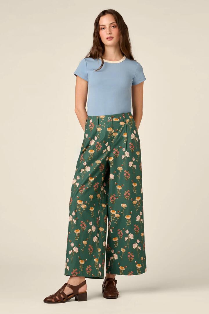 Image of a model wearing Pants. Product name - Native Bee & Flora Pant in Green colour by brand - Princess Highway