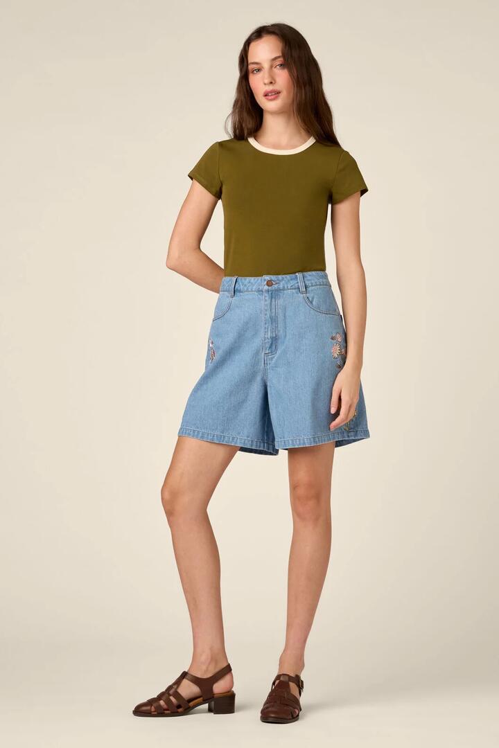 Image of a model wearing Shorts. Product name - Strawflower Embroidered Short in Blue Denim colour by brand - Princess Highway