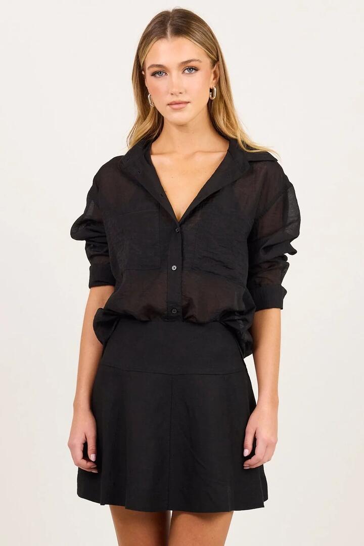 Image of a model wearing Skirts. Product name - Deduction Black Linen Blend Flared Mini Skirt in Black colour by brand - Stories be Told