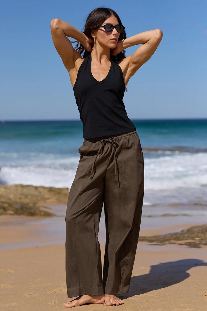 Image of a model wearing Pants. Product name - Transit Olive Pull On Waist Tie Barrel Leg Pants in Olive colour by brand - Ivy + Jack