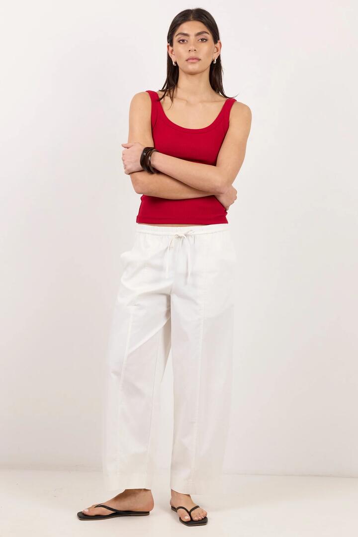 Image of a model wearing Pants. Product name - Transit White Pull On Waist Tie Barrel Leg Pants in White colour by brand - Ivy + Jack