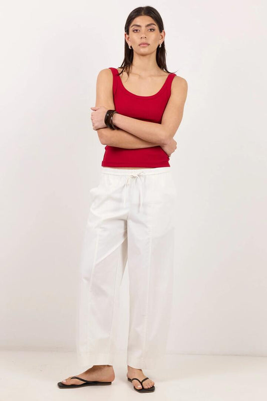 Image of a model wearing Pants. Product name - Transit White Pull On Waist Tie Barrel Leg Pants in White colour by brand - Ivy + Jack