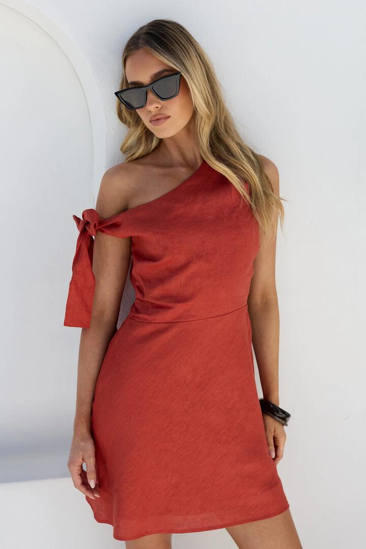 Image of Dresses. Product name - Reflect Cinnamon Linen One Shoulder Bow Mini Dress in Cinnamon colour by brand - Among the Brave