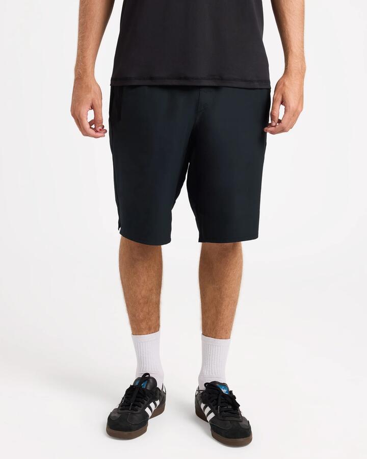 Image of a model wearing Shorts. Product name - Rvca Mens Yogger Long Length 20" Workout Shorts Black in Black colour by brand - Rvca