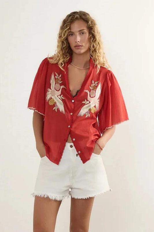 Image of a model wearing Tops. Product name - Zoe Red Embroidery Scallop Hem SS Blouse in Red colour by brand - Auguste The Label