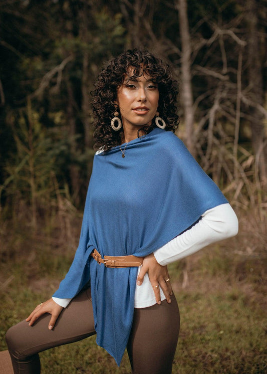 Image of a model wearing Outerwear. Product name - Carrie Cashmere & Bamboo Knit Poncho Ocean Blue in Ocean Blue colour by brand - Lou Lou
