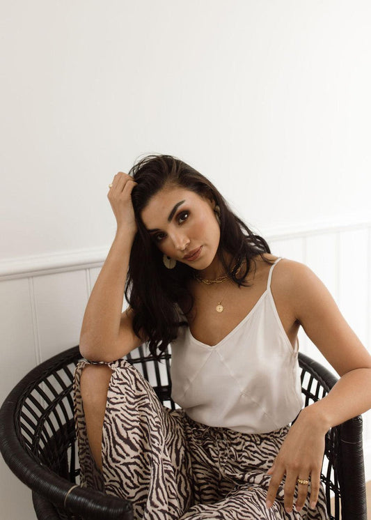 Image of a model wearing Tops. Product name - Clover Sleeveless Silk Cami Pearl in Pearl colour by brand - Lou Lou
