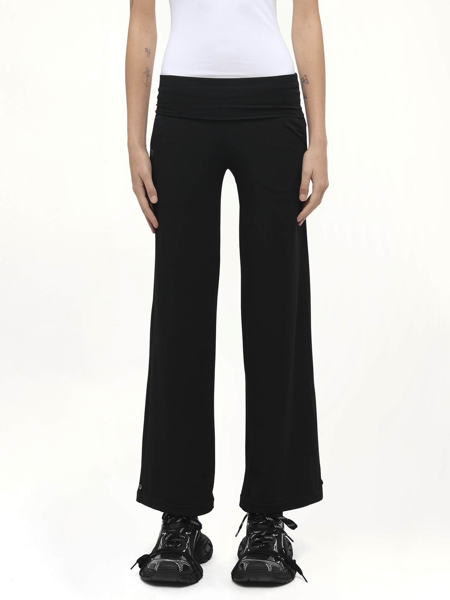 Image of a model wearing Pants. Product name - Afternoon Stretch Series Folded High Waisted Pants in Black colour by brand - FAX COPY EXPRESS
