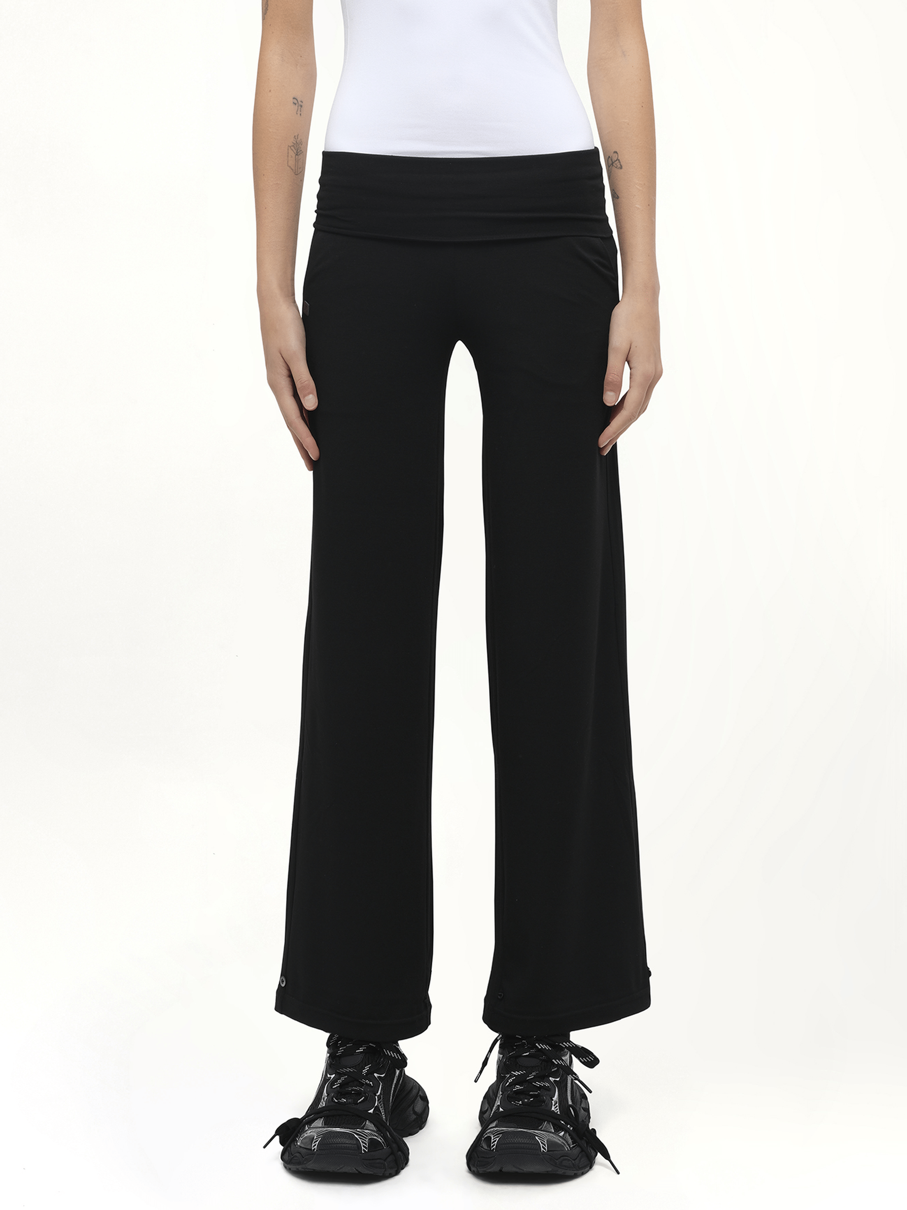 Image of a model wearing Pants. Product name - Afternoon Stretch Series Folded High Waisted Pants in Black colour by brand - FAX COPY EXPRESS