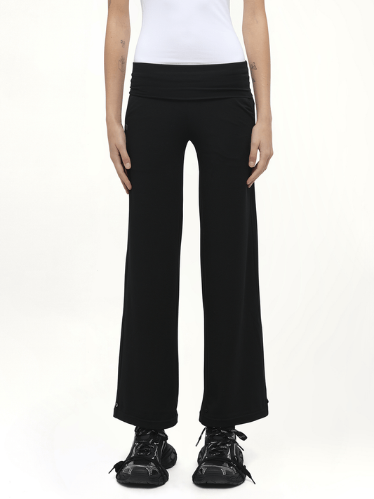 Image of a model wearing Pants. Product name - Afternoon Stretch Series Folded High Waisted Pants in Black colour by brand - FAX COPY EXPRESS