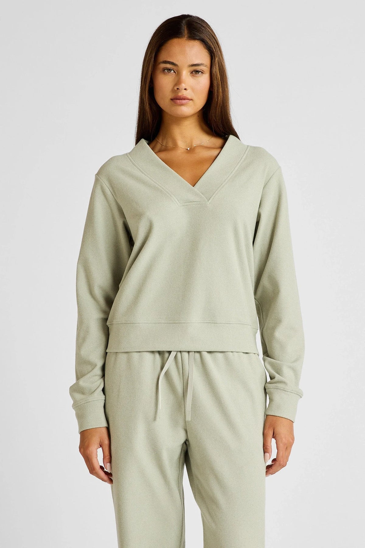 Image of a model wearing Outerwear. Product name - Micro-Rib V-Neck Cropped Sweater in Seagrass colour by brand - All Fenix