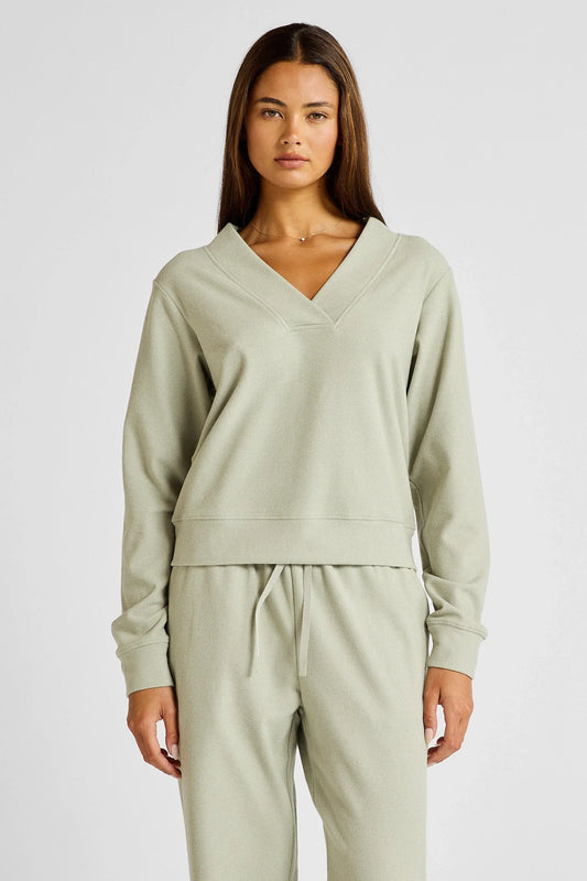 Image of a model wearing Outerwear. Product name - Micro-Rib V-Neck Cropped Sweater in Seagrass colour by brand - All Fenix