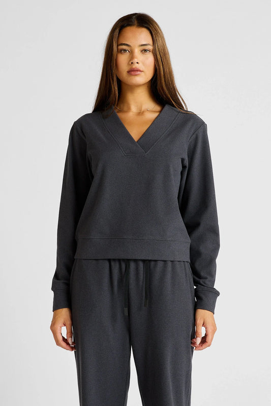 Image of a model wearing Outerwear. Product name - Micro-Rib V-Neck Cropped Sweater in Charcoal colour by brand - All Fenix