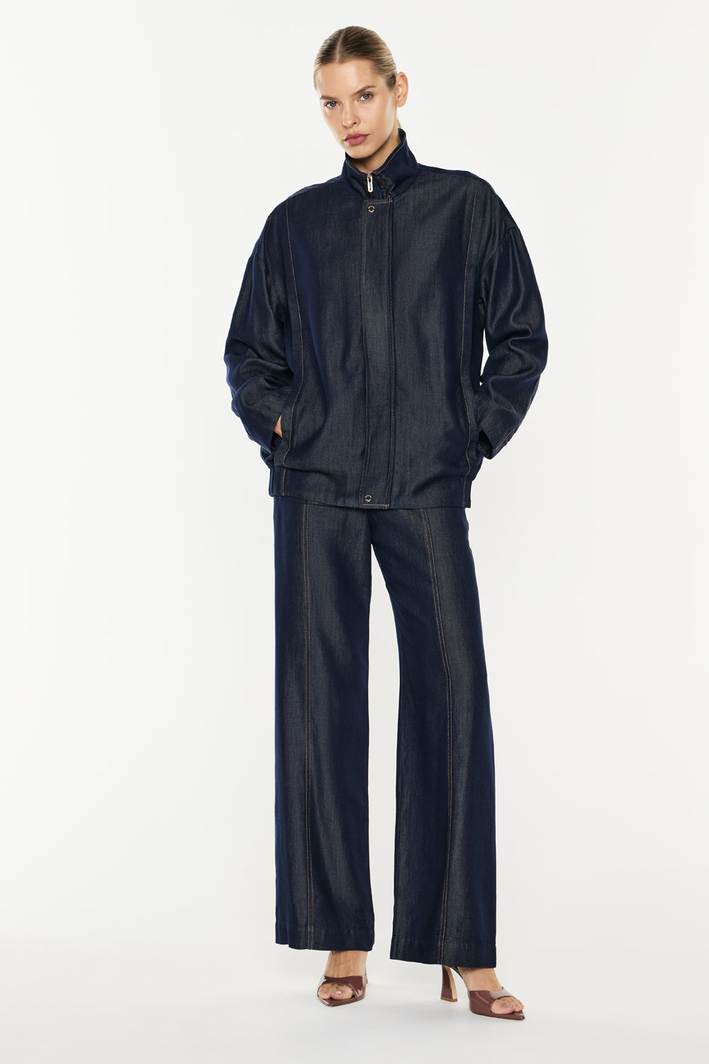 Image of a model wearing Outerwear. Productname: Quiet Command Bomber Jacket in Indigo colour by brand - Manning Cartell