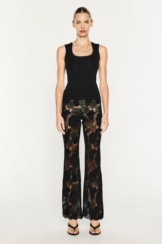Image of a model wearing Pants. Product name - Sheer Force Bootleg Pant in Black colour by brand - MANNING CARTELL