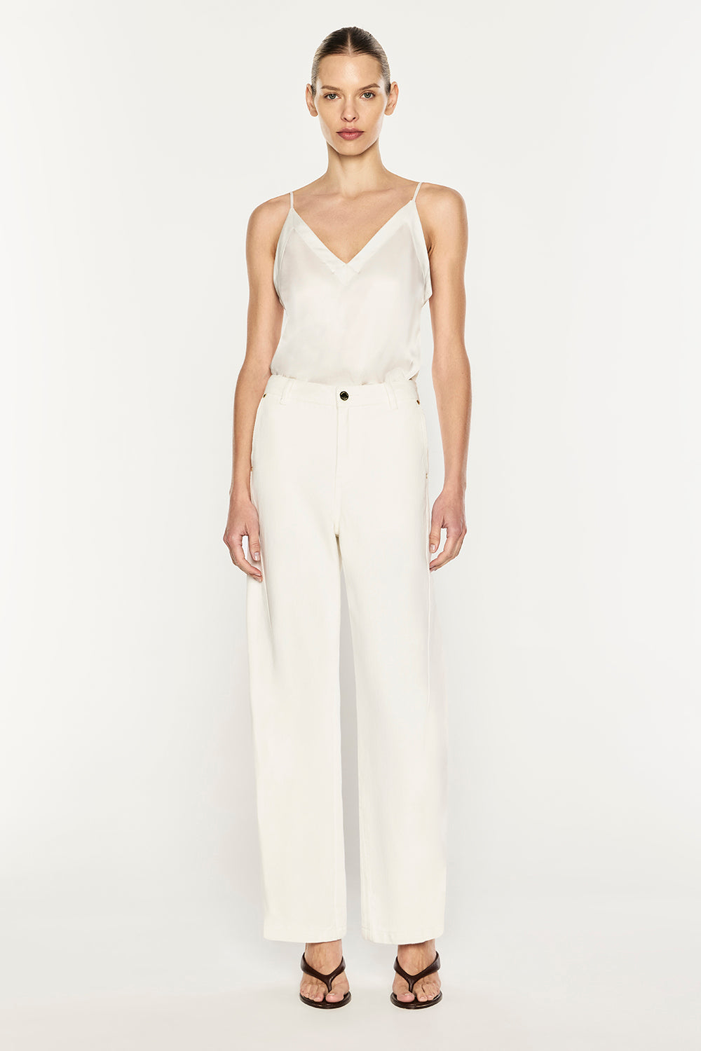 Image of a model wearing Pants. Product name - Clean Slate Barrel Jean in Off White colour by brand - MANNING CARTELL