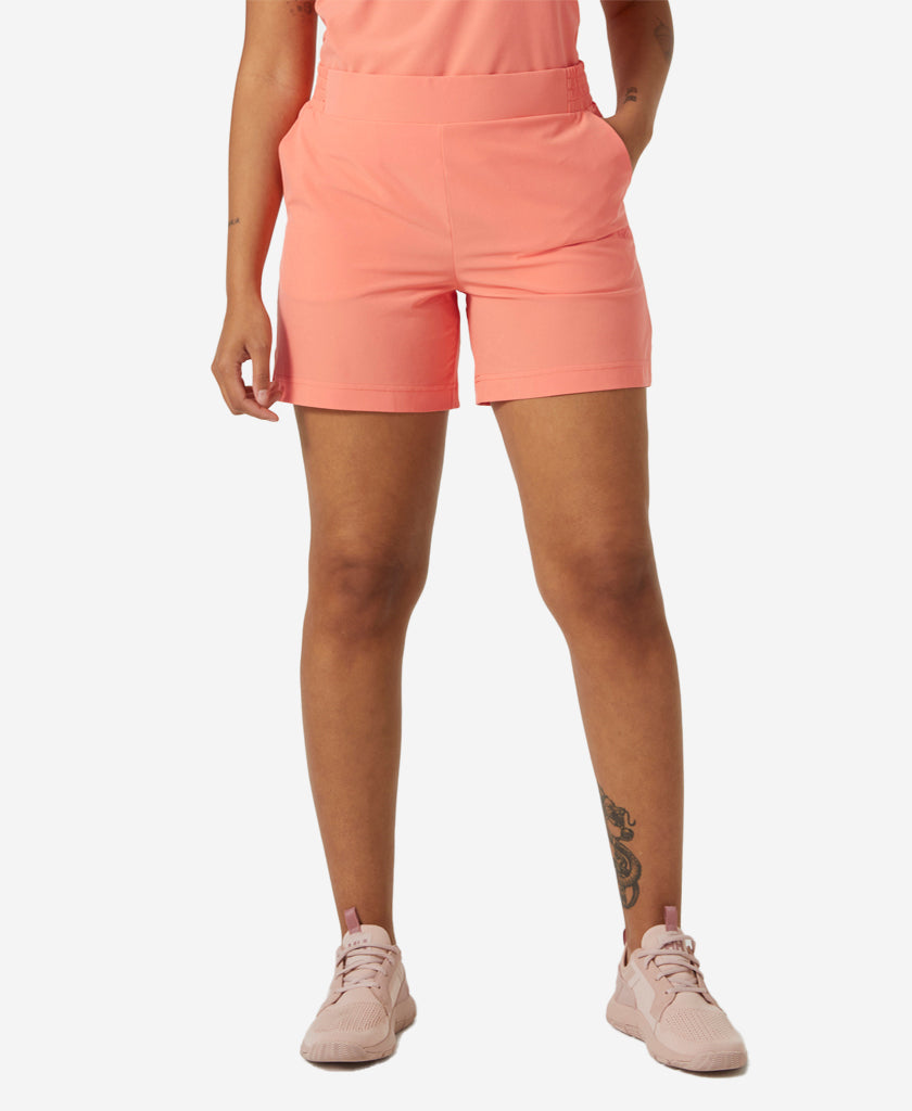 Image of a model wearing Shorts. Product name - W THALIA SHORTS 2.0, Peach Echo in Peach Echo colour by brand - Helly Hansen
