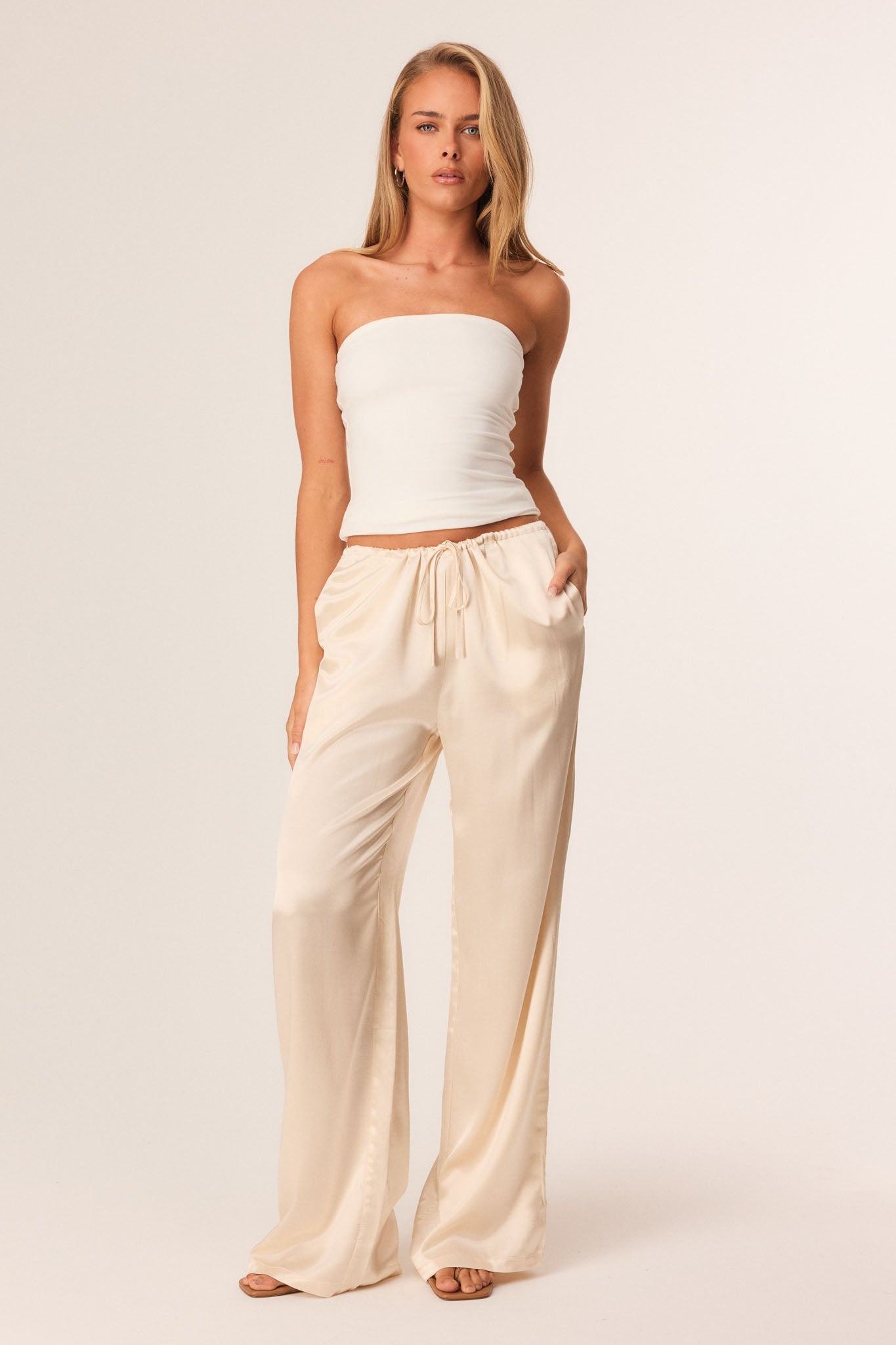 Image of a model wearing Pants. Productname: SNDYS DOVE PANTS in Creme colour by brand - SNDYS