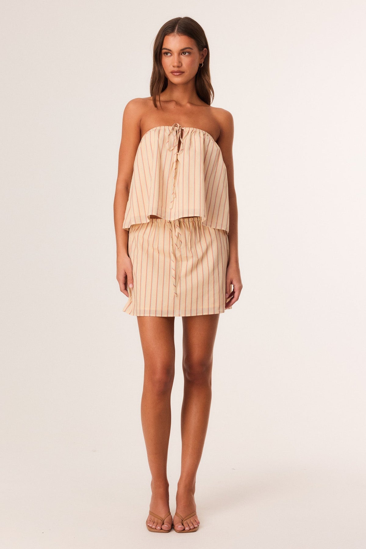 Image of a model wearing Skirts. Productname: SNDYS SARA MINI SKIRT in Butter Stripe colour by brand - SNDYS