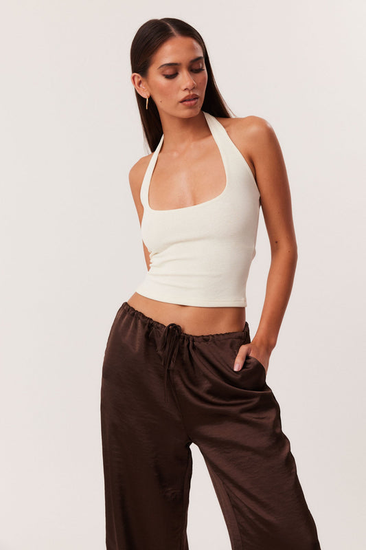 Image of a model wearing Tops. Productname: SNDYS KATYA HALTERNECK TOP in Off White colour by brand - SNDYS