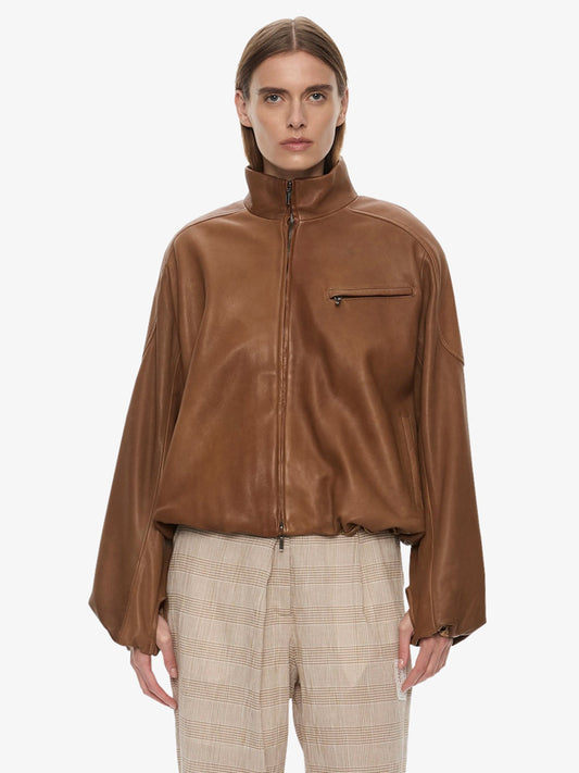 Image of a model wearing Outerwear. Product name - Dannie Leather Bomber in Mud colour by brand - CHRISTOPHER ESBER