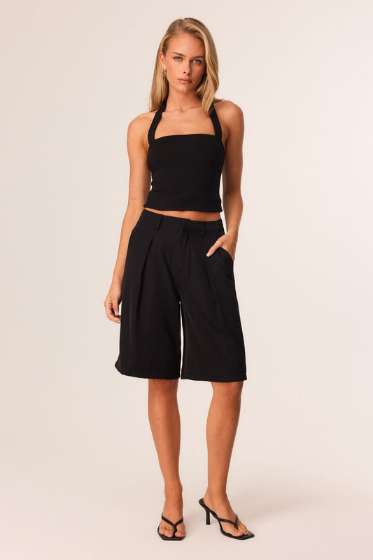 Image of a model wearing Tops. Productname: SNDYS TOMI TOP in Black colour by brand - SNDYS