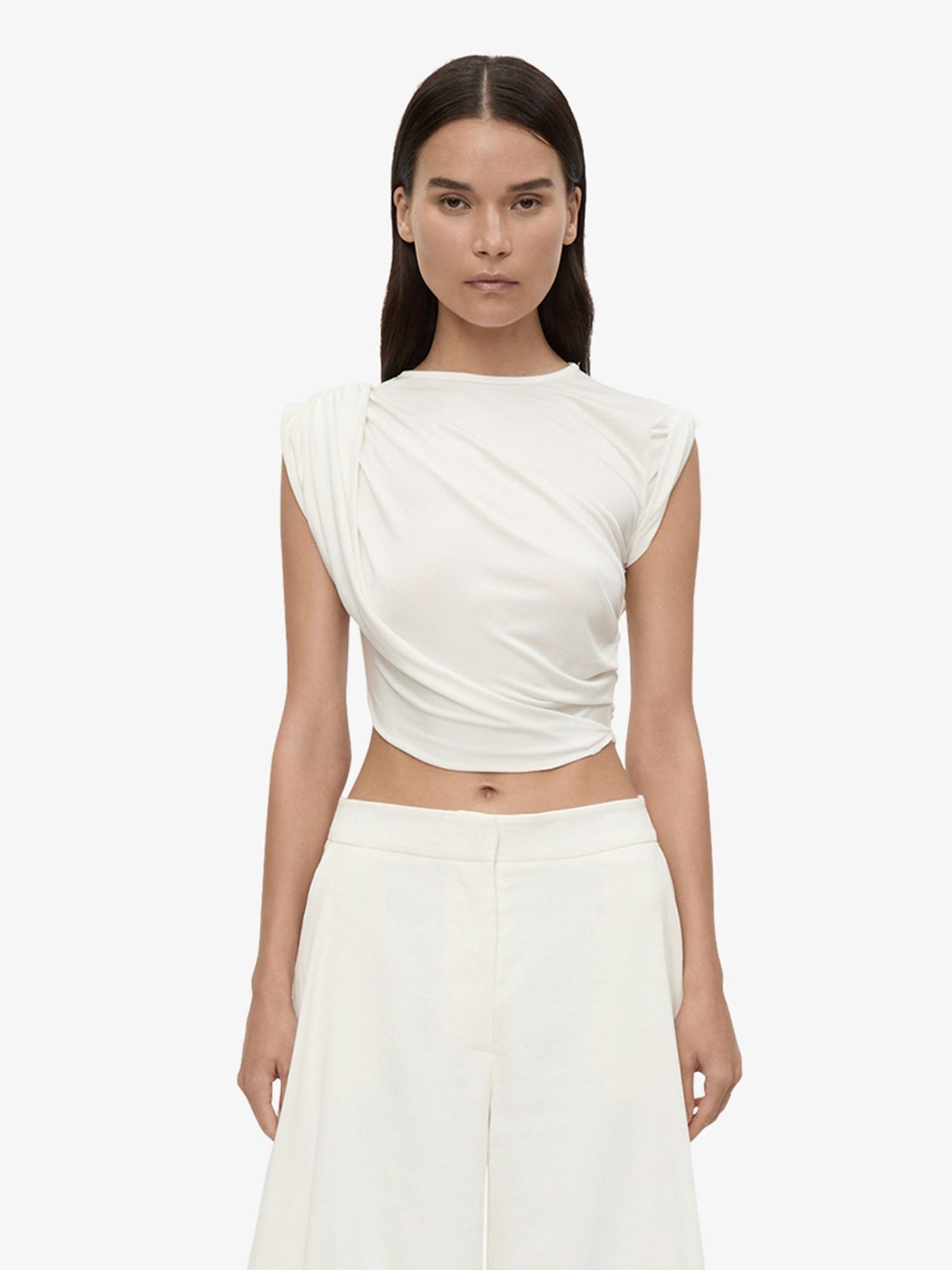 Image of a model wearing Tops. Product name - Verve Twisted Tank in Tank colour by brand - Christopher Esber