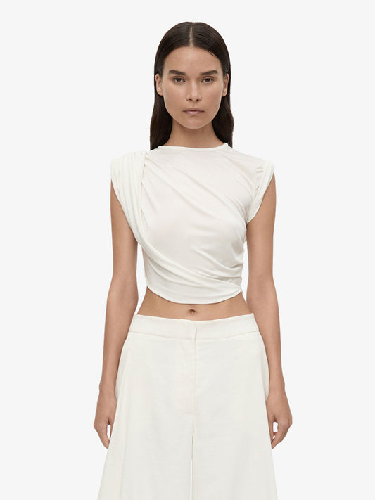 Image of a model wearing Tops. Product name - Verve Twisted Tank in Tank colour by brand - Christopher Esber