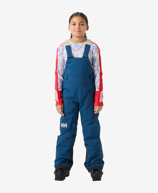 Image of a model wearing Pants. Product name - JR GIRL STELLAR BIB PANT, Dark Blue in Dark Blue colour by brand - Helly Hansen